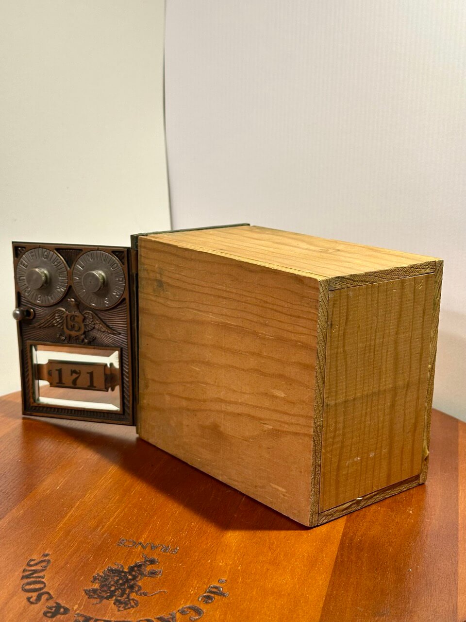 Wooden box with metal reel on a wooden surface