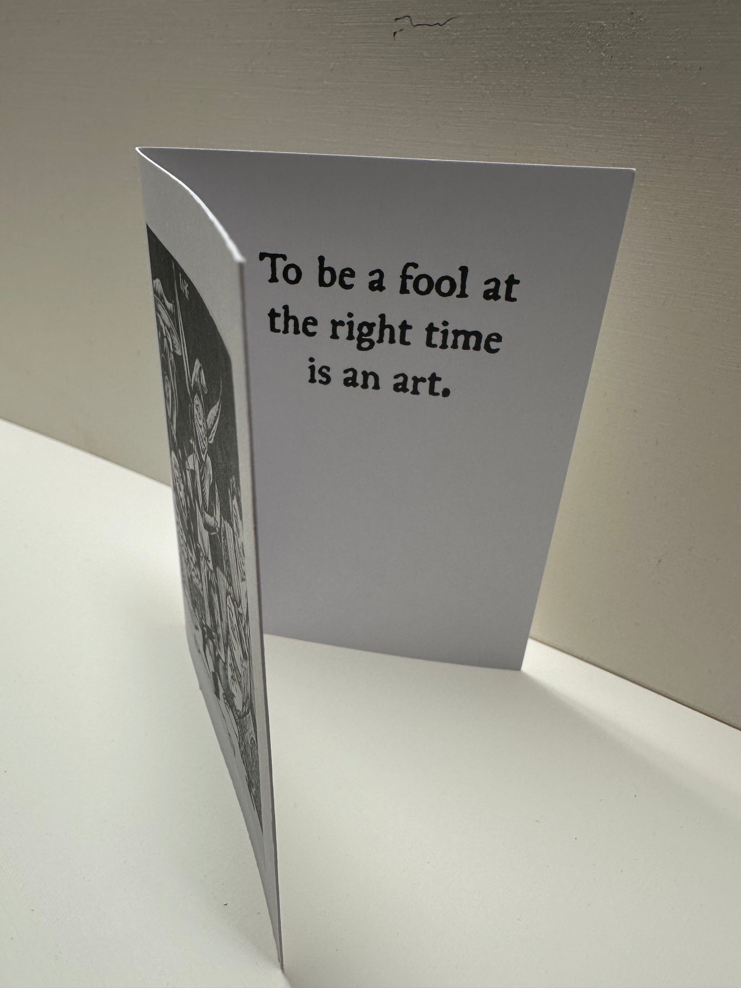 Inside view of "Fool at a Banquet" card. It reads: To be a fool at the right time is an art.