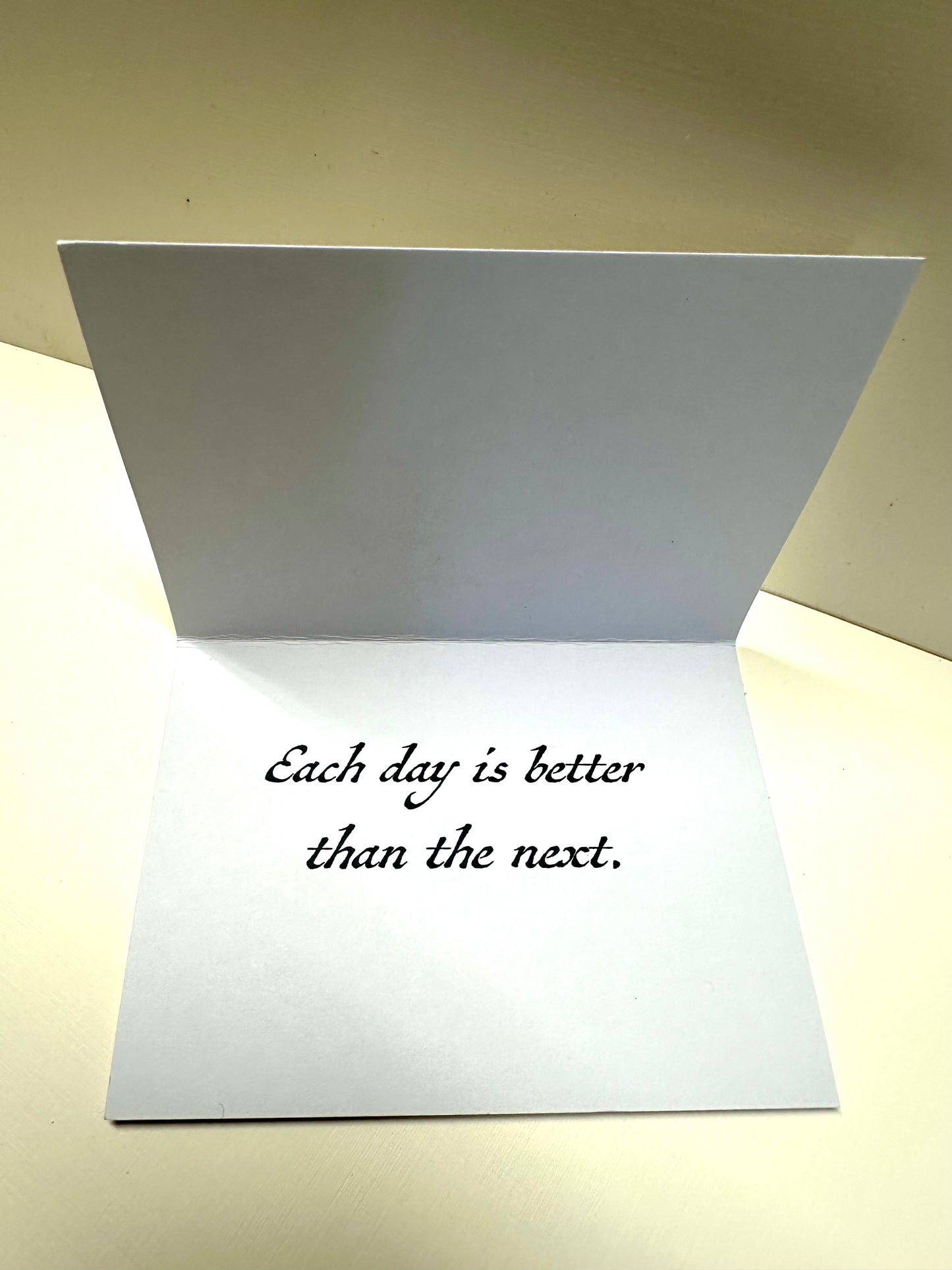 Opened card that says 'Each day is better than the next.'