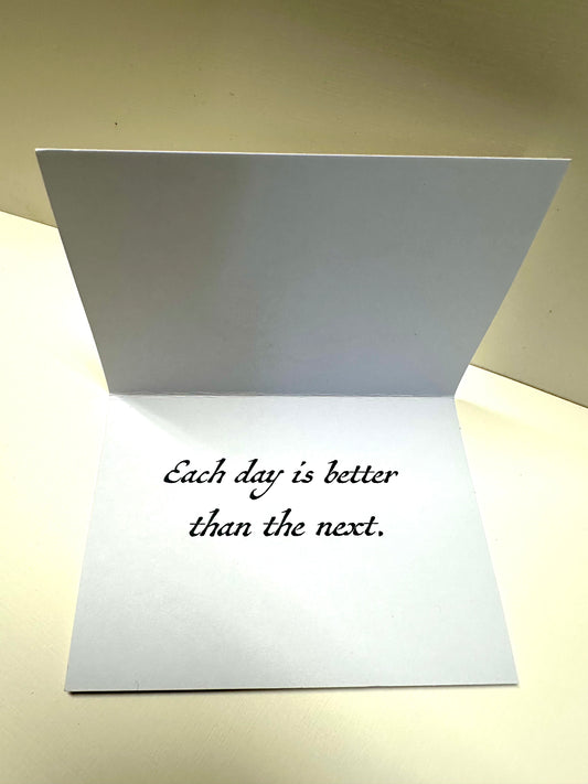 Opened card that says 'Each day is better than the next.'