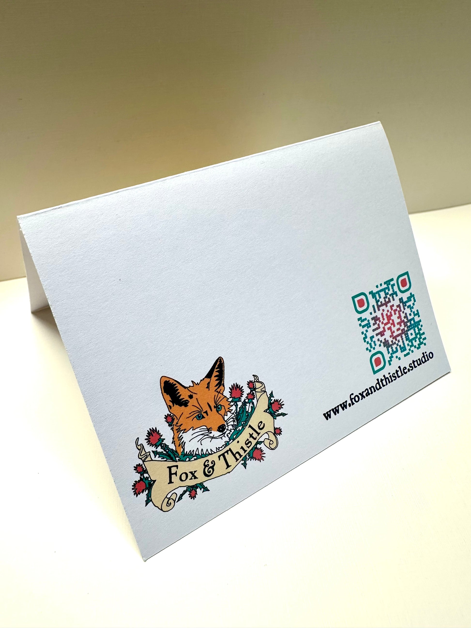 Back view of Fox & Thistle Studio's peacock card.