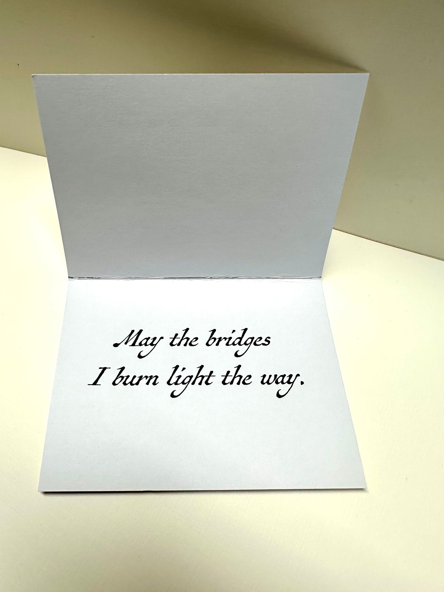 Interior of 'Crossroads Card' that reads: May the bridges I burn light the way.