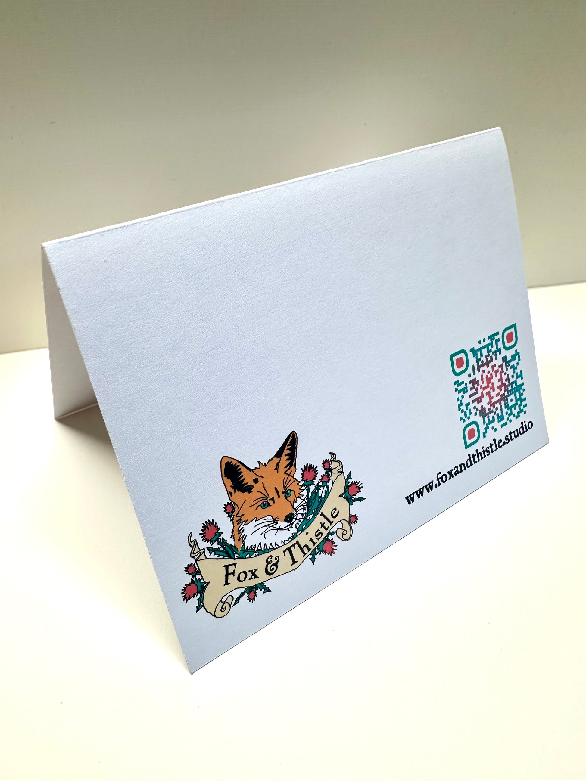 Back of greeting card with studio contact information.