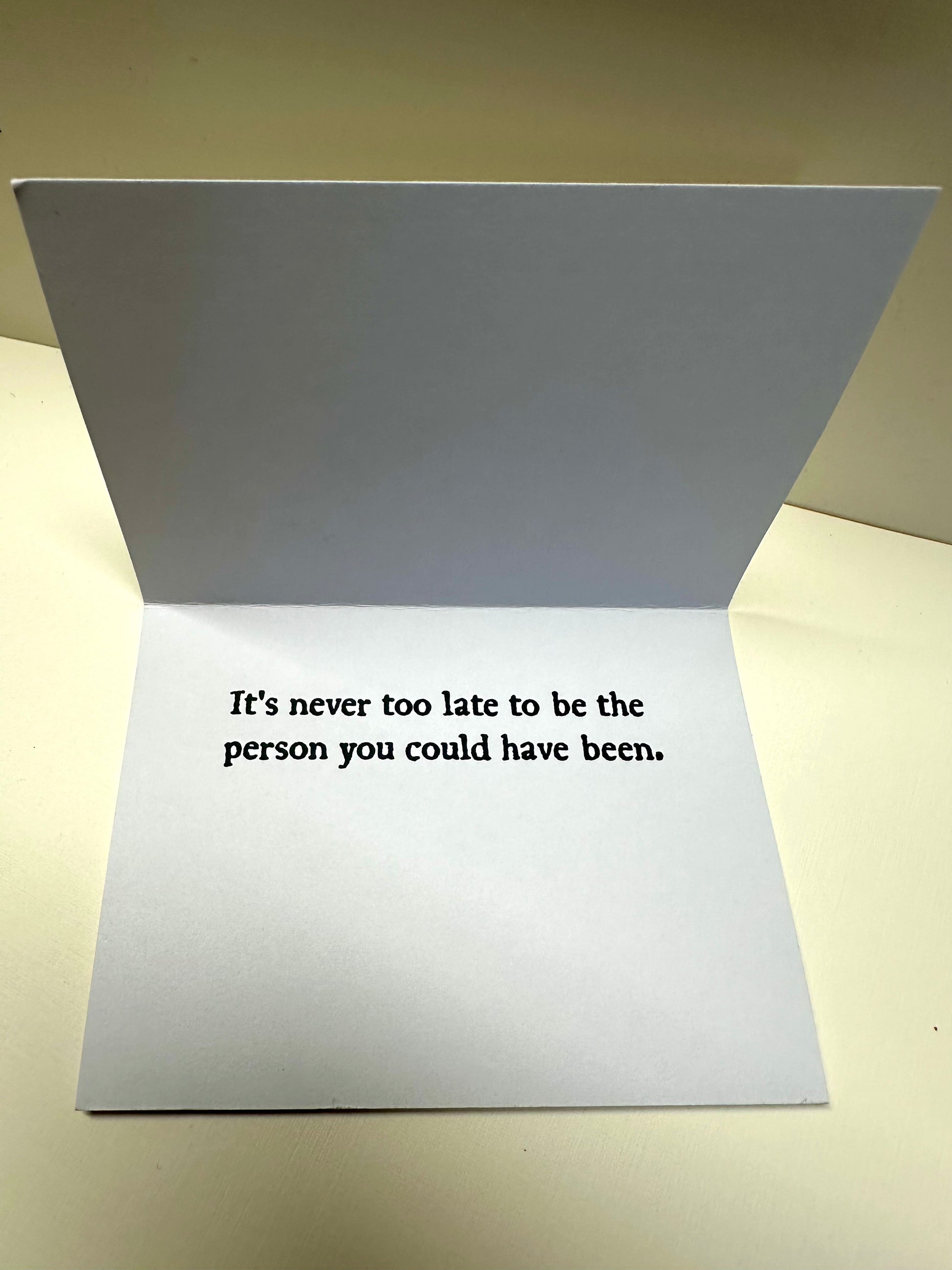 Interior flap of 'Stasis Card' that says: It's never too late to be the person you could have been.