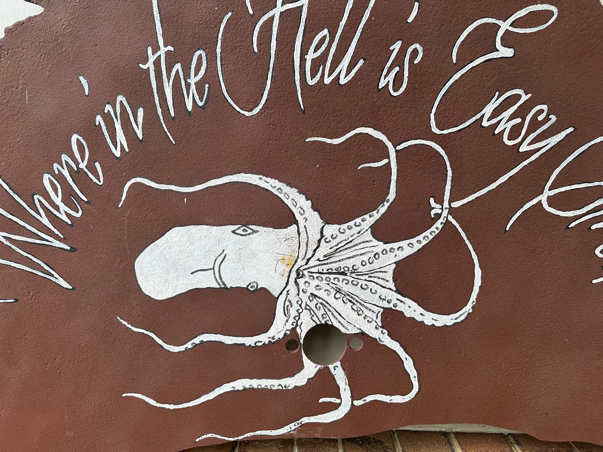 Brown sawblade with white octopus illustration and text 'Where in the Hell is Eddy V?'
