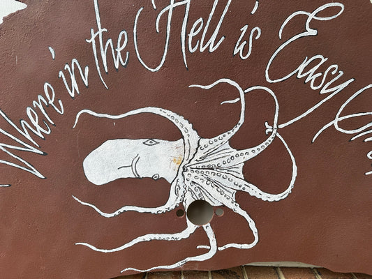 Brown sawblade with white octopus illustration and text 'Where in the Hell is Eddy V?'