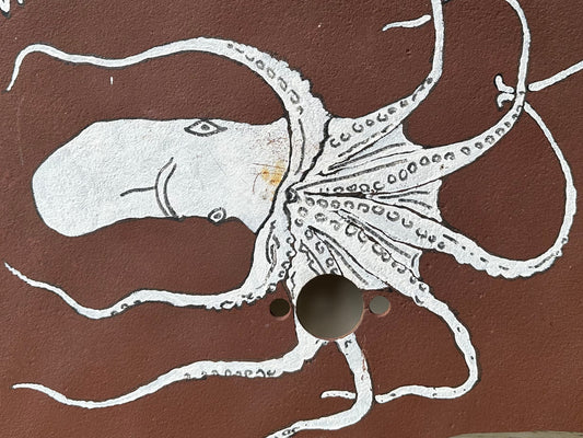 Brown sawblade with white octopus illustration and text 'Where in the Hell is Easy Street?'