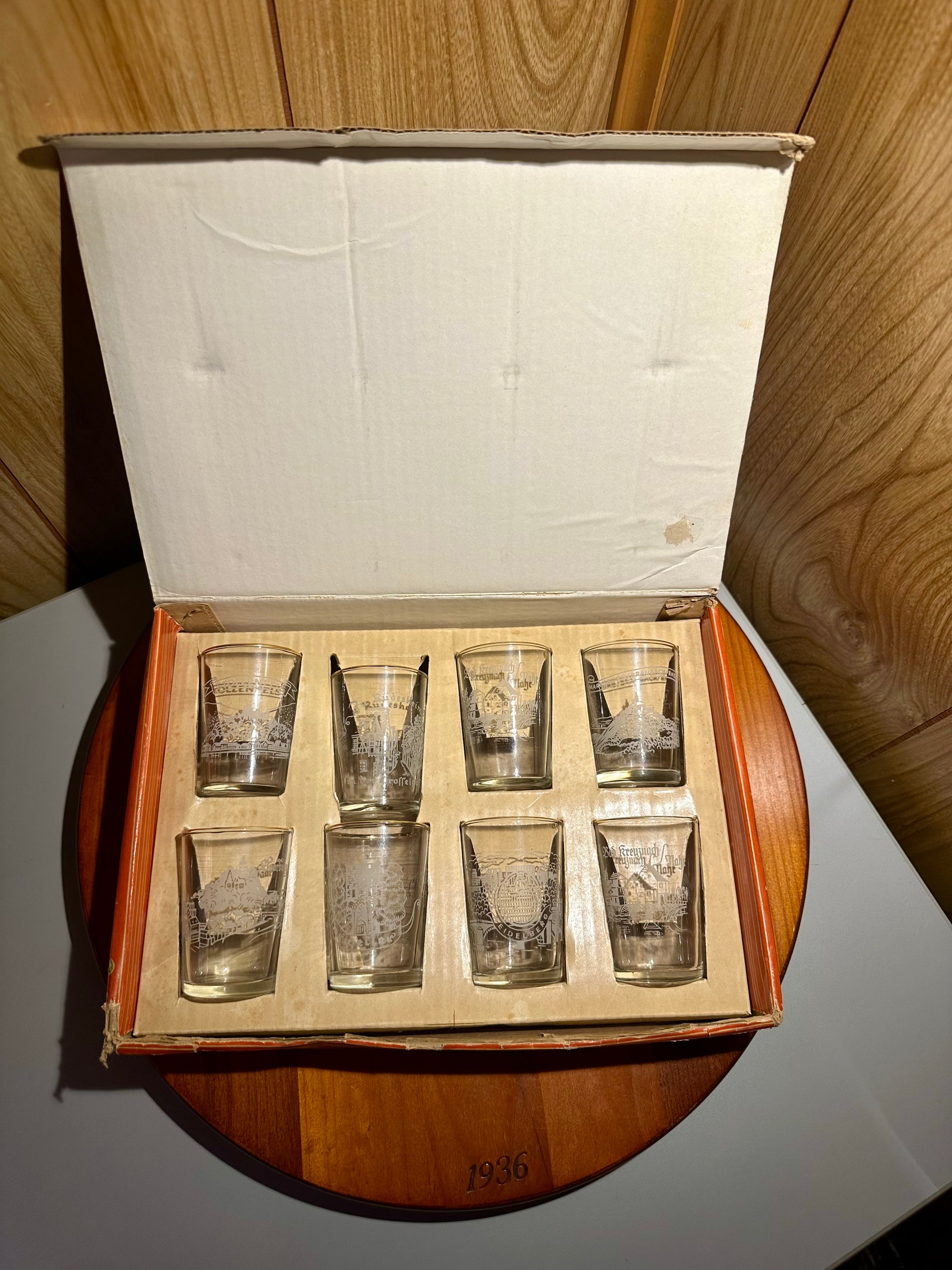Set of eight wine glasses in a wooden box on a wooden surface