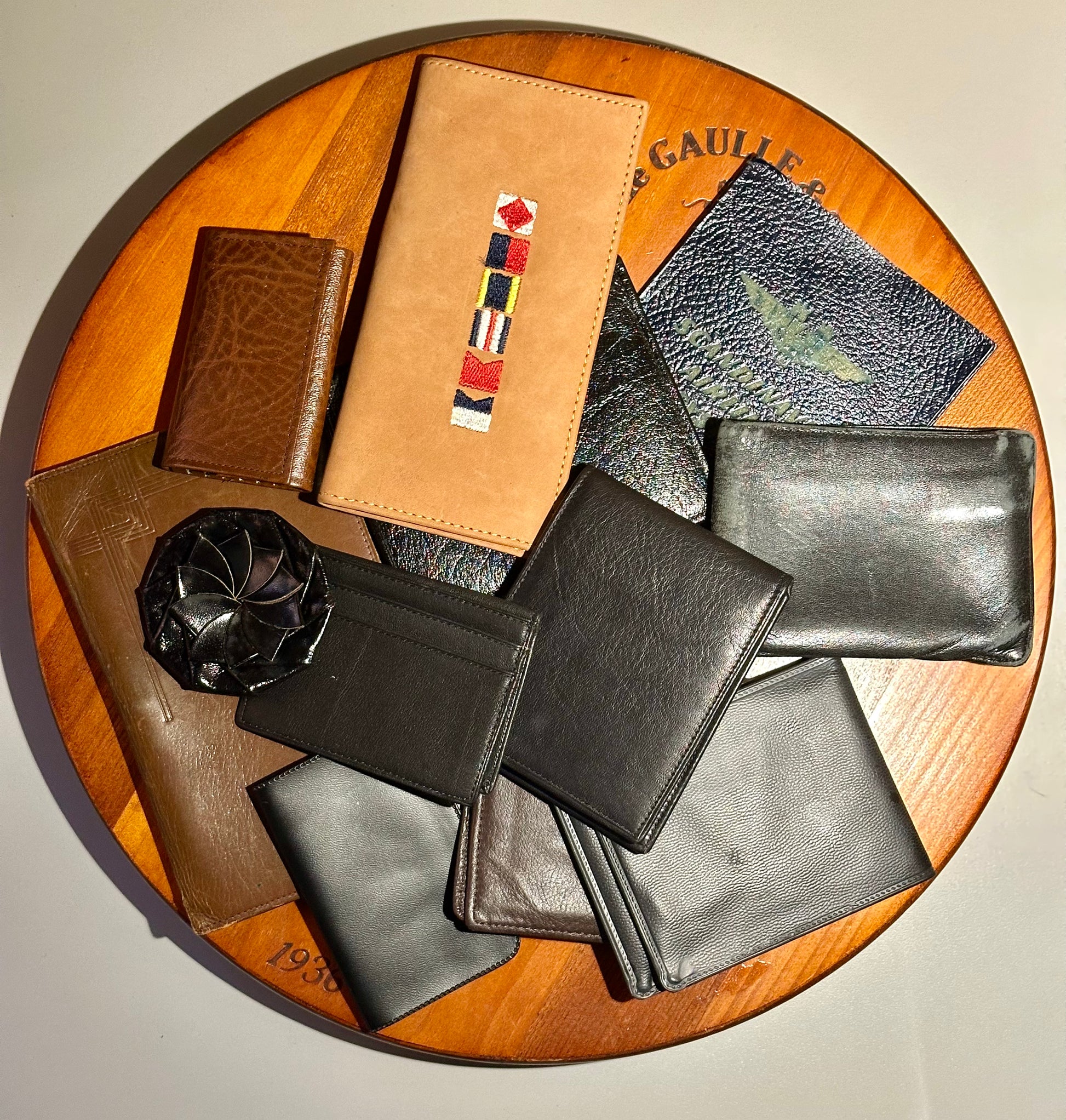 Collection of leather wallets on a wooden surface