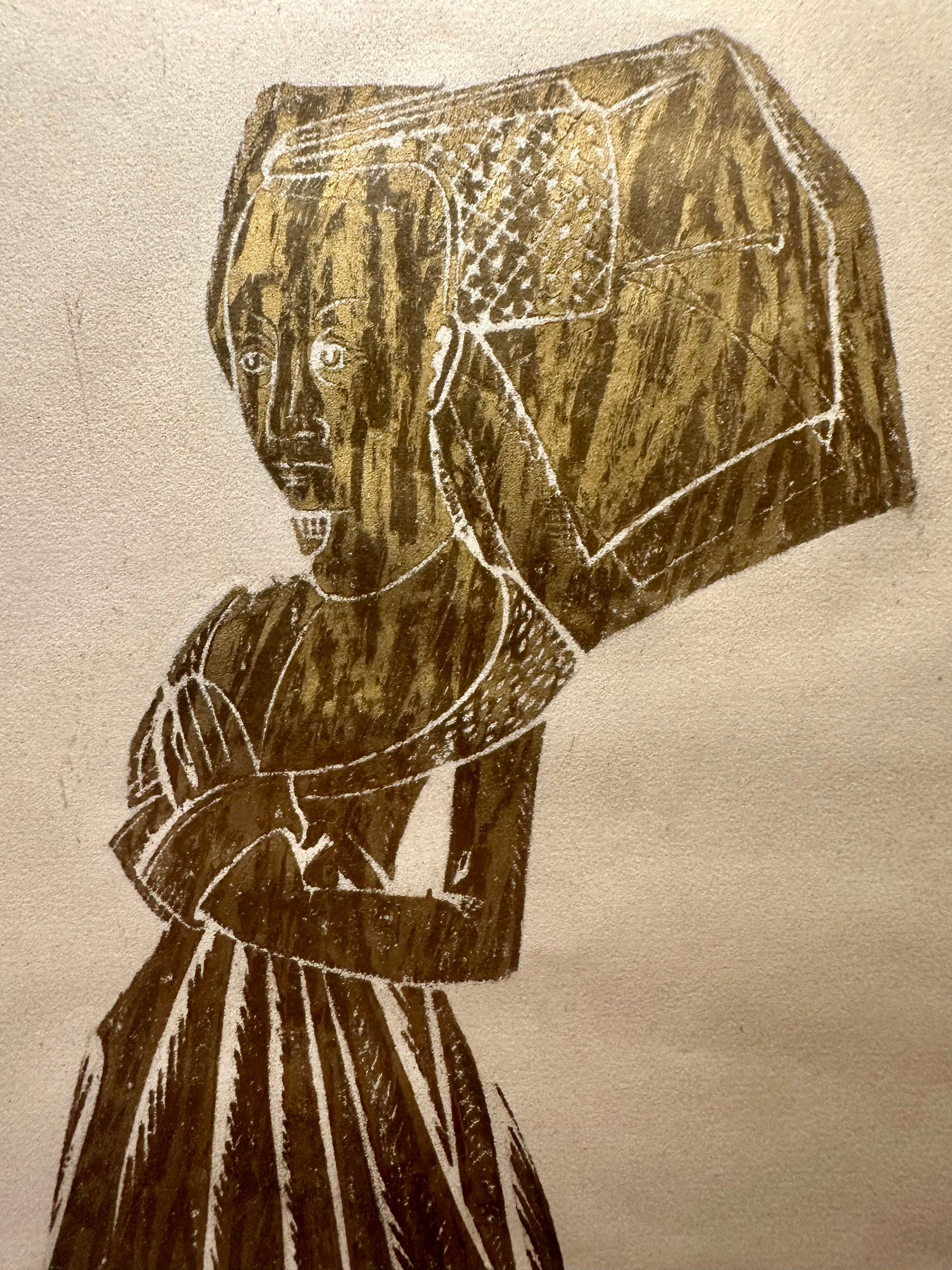 Brass rubbing close up of a person wearing a traditional headscarf on a beige background