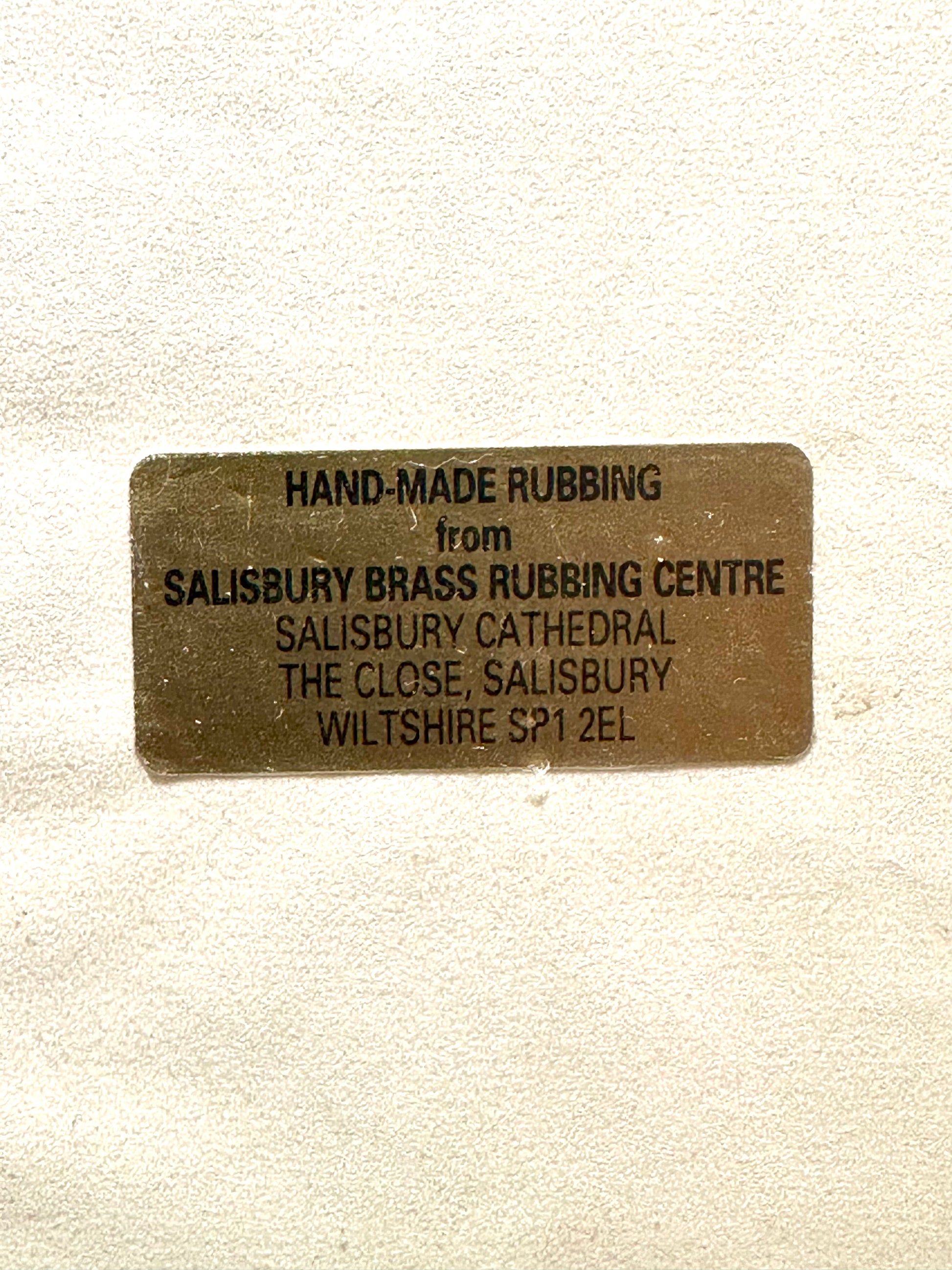 Brass rubbing label from Salisbury Brass Rubbing Centre on a beige background