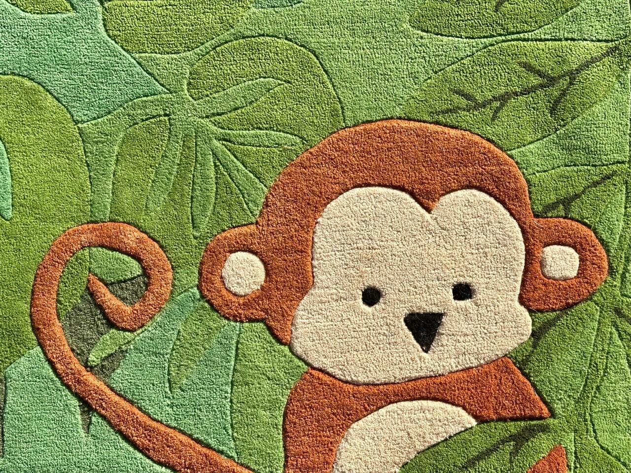 Rug with a monkey design on a green leafy background