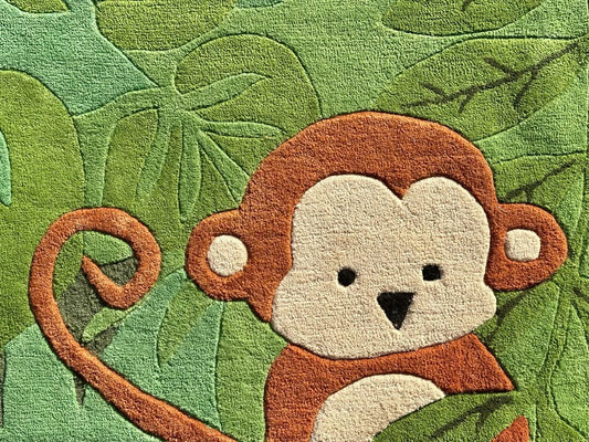Rug with a monkey design on a green leafy background