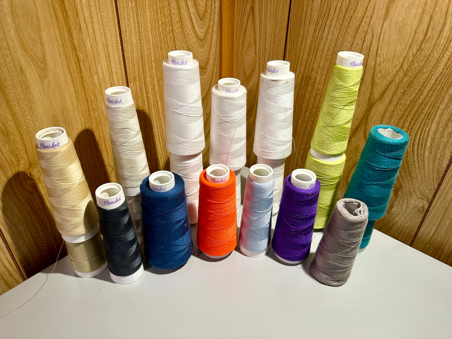 Assorted spools of thread on a wooden surface