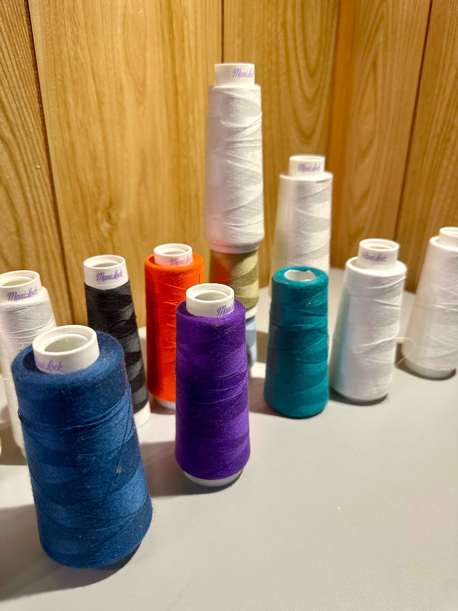 Spools of colorful thread on a wooden surface