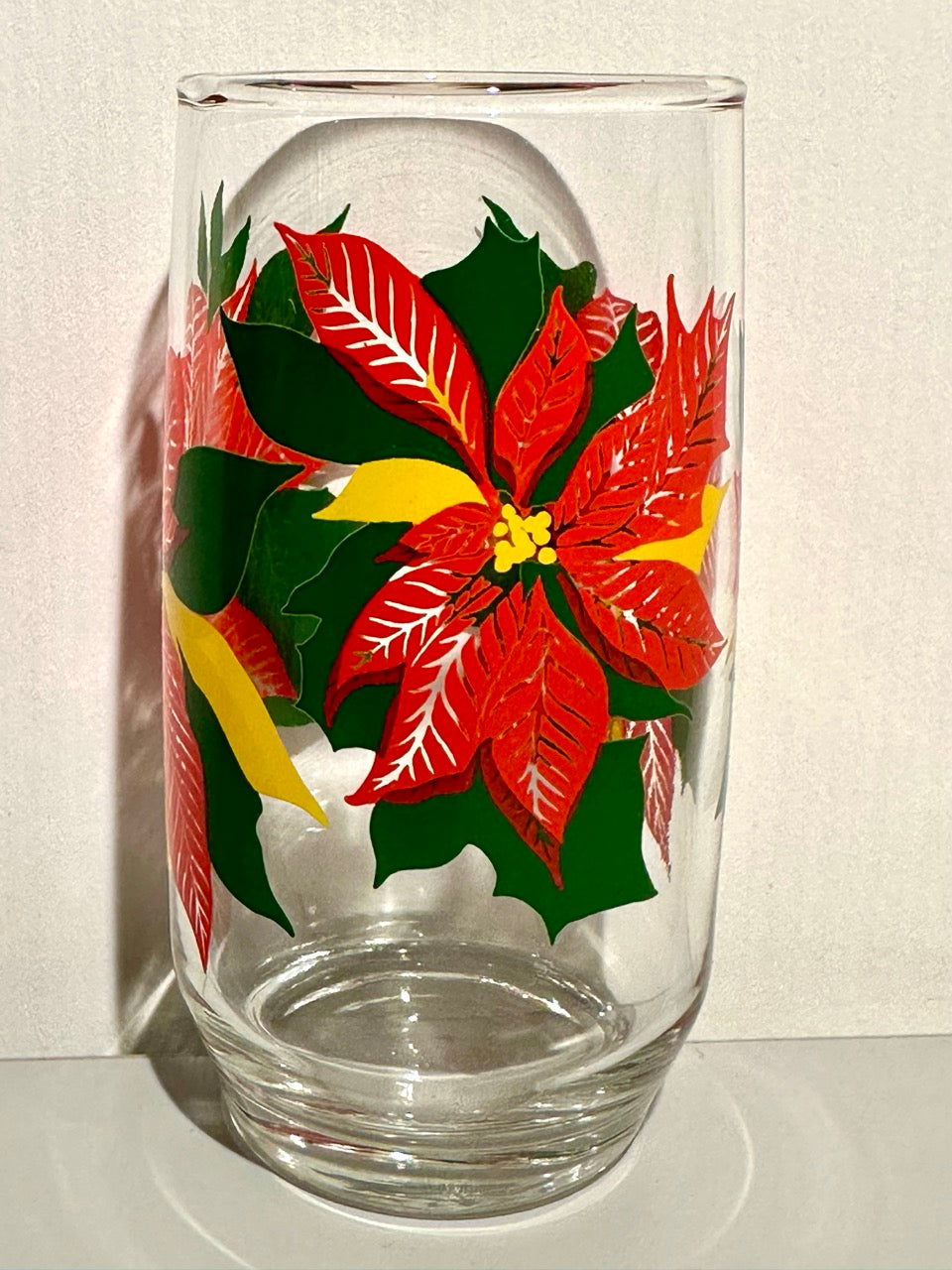 Clear glass with red poinsettia design on a white background