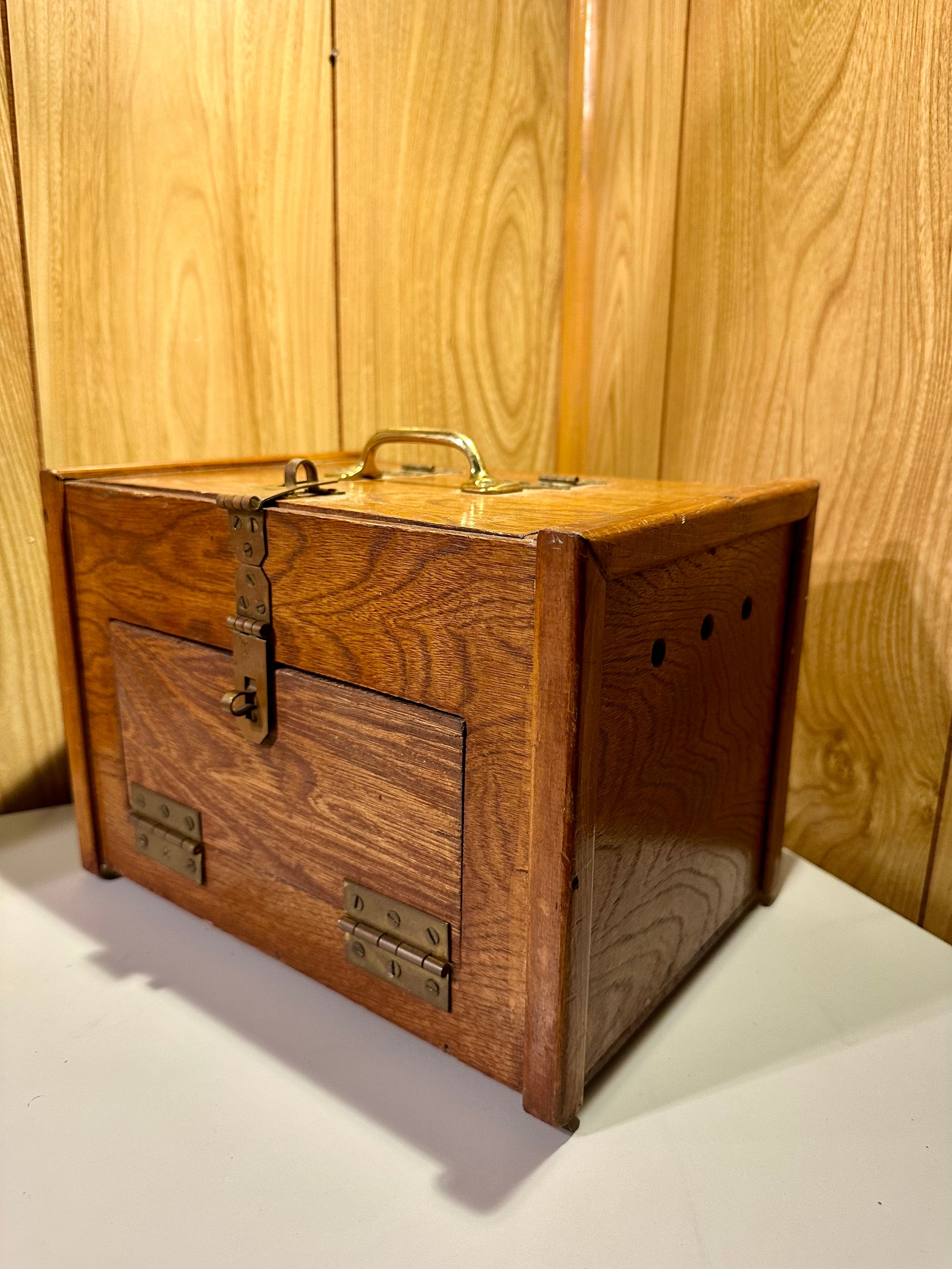 Wooden box with brass hardware on a wooden background