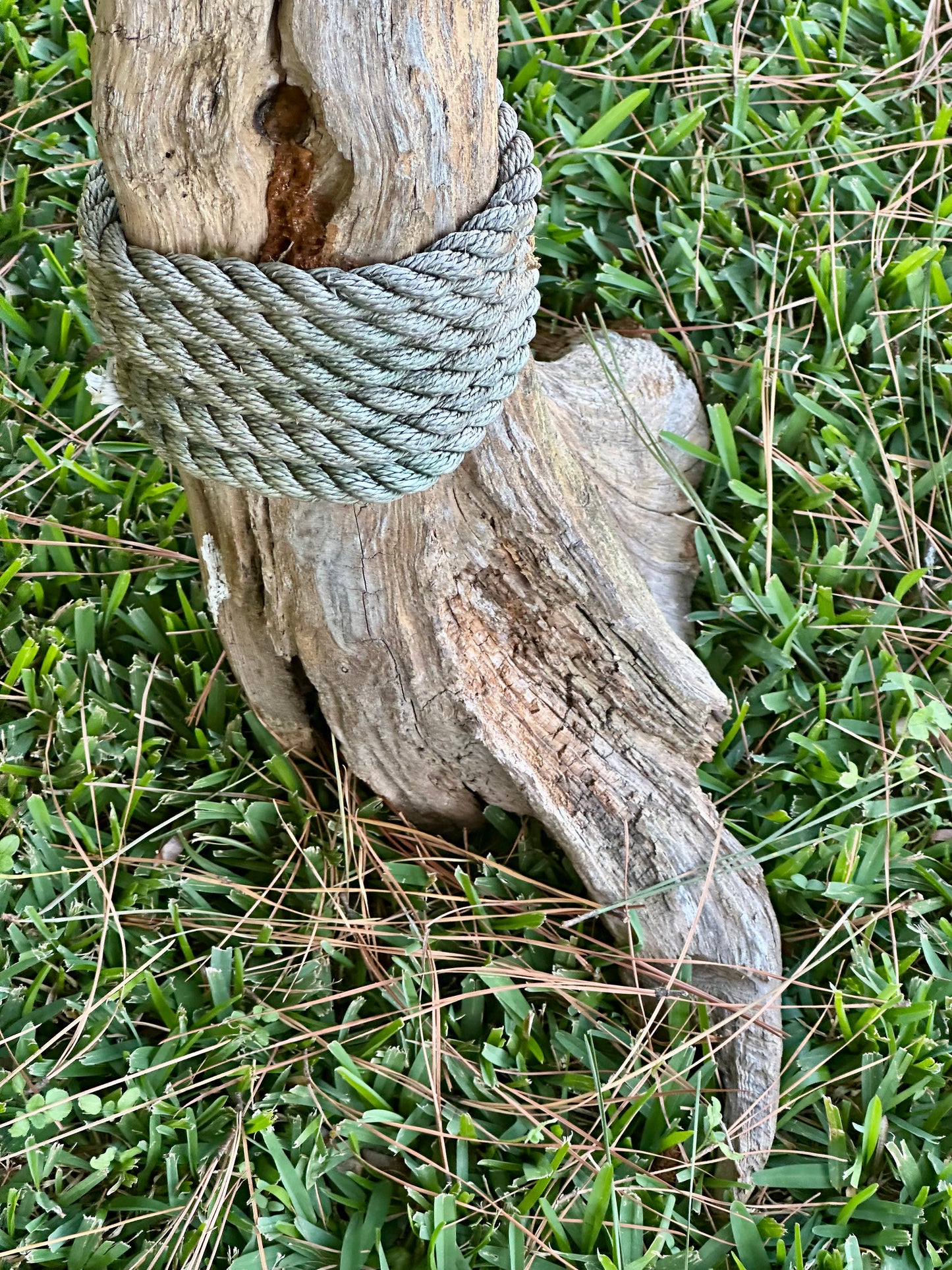 Rope tied around a wooden arch foot  on grass