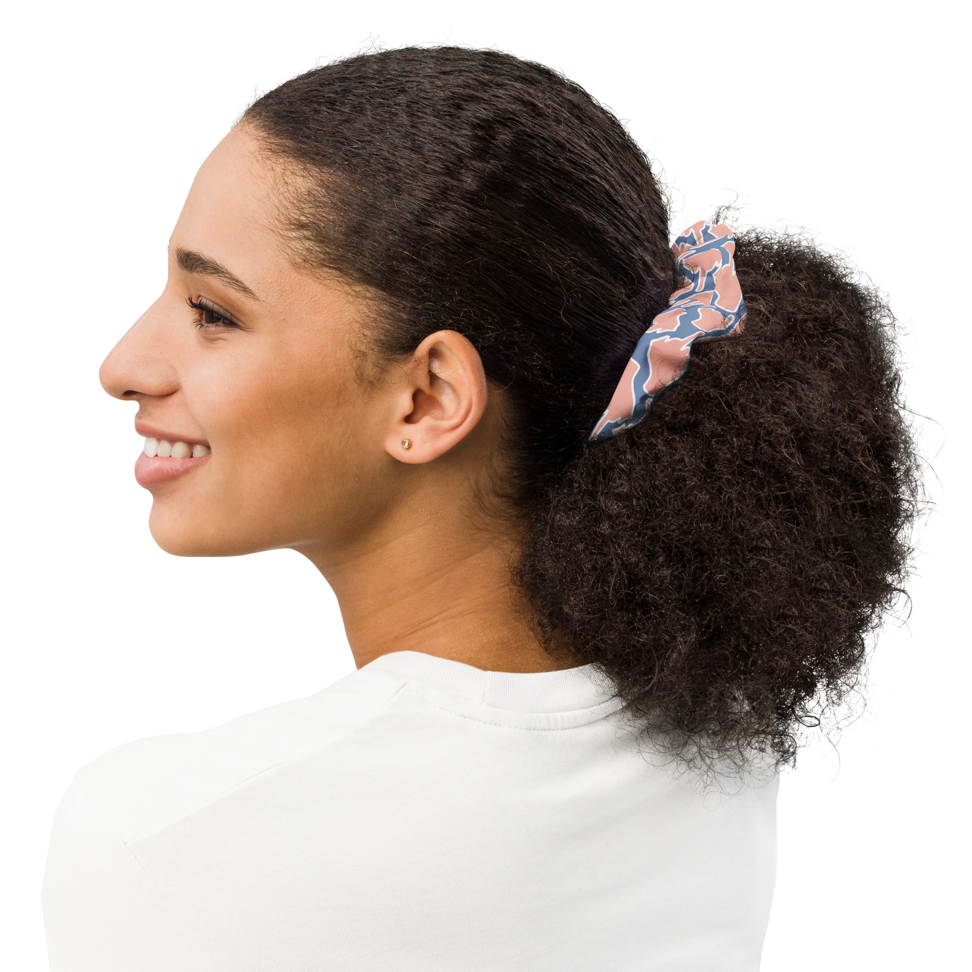 One Finger Wave scrunchie, shown from the side, in salmon and steel blue — eye-catching two-tone design with subtle linear motif on recycled fabric.