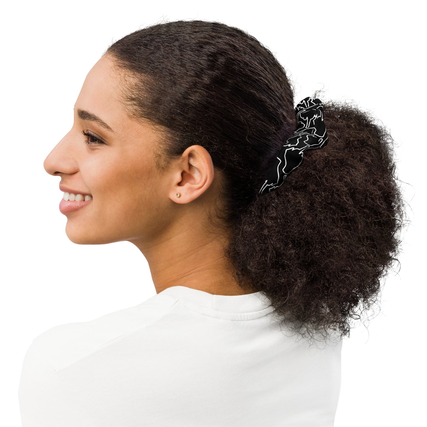 Side view of woman wearing black One Finger Wave scrunchie featuring subtle white linear illustrations — sustainable, stylish hair tie with a quiet edge.