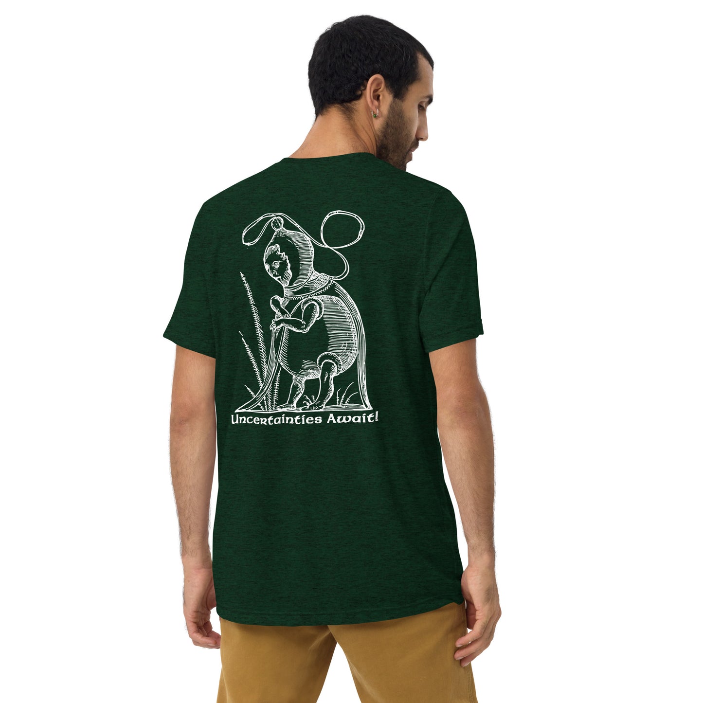 Backview of model in emerald green “Uncertainties Await” tee, showcasing a surreal woodcut design.