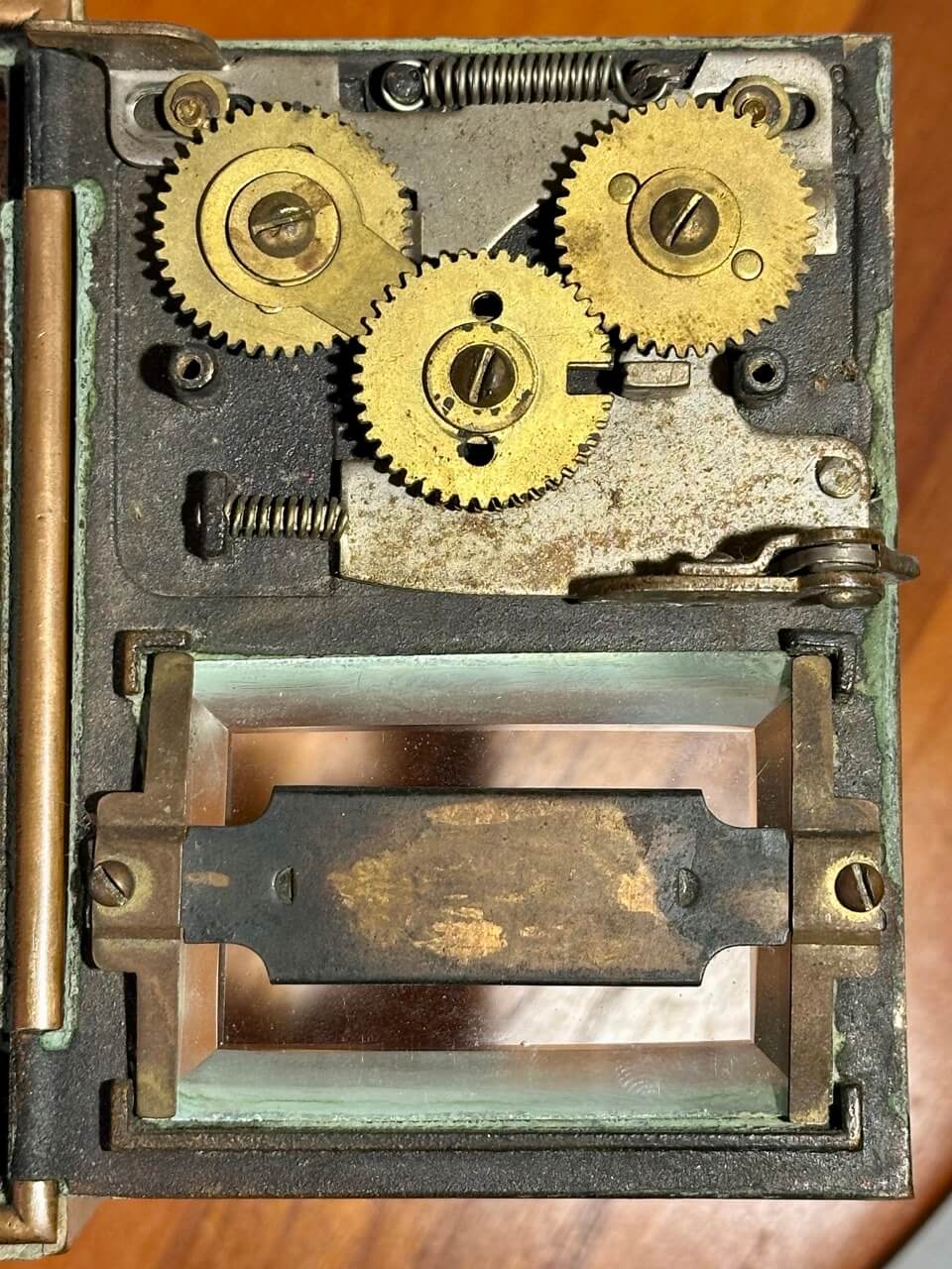 Close-up of an antique safe mechanism with gears and springs.