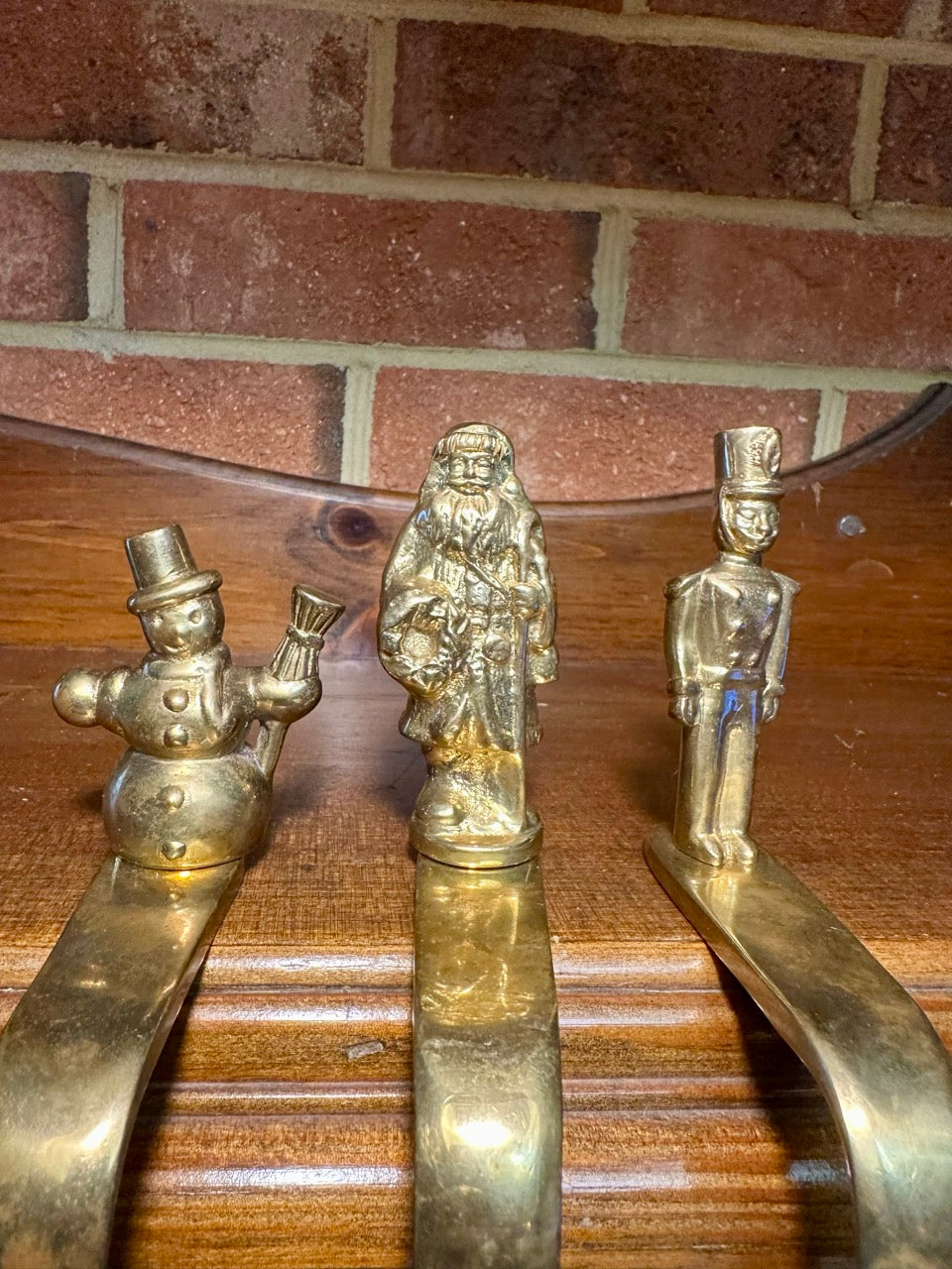 Closeup of Santa, snowman, and toy soldier brass figures.