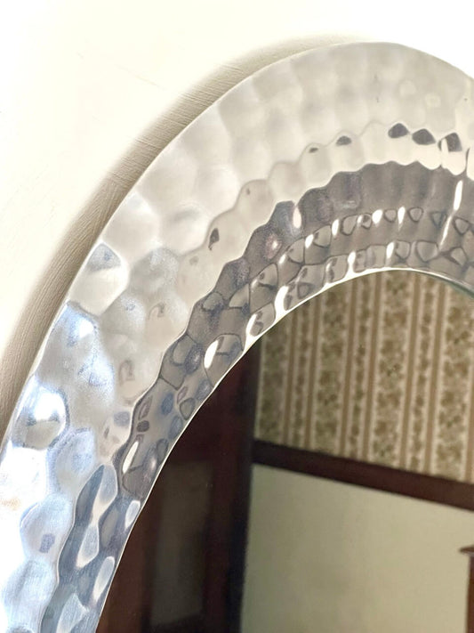 Close-up of a metallic circular object with a textured surface.