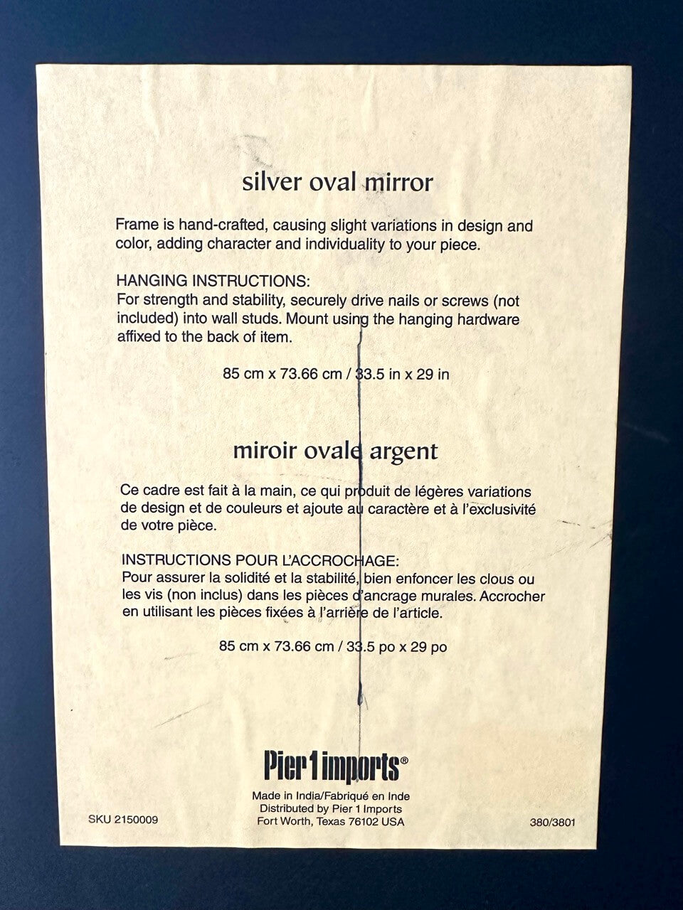 Instructions for a silver oval mirror on a beige background