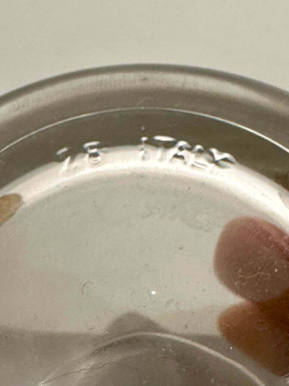 Close-up of a glass embossed with "28 ITALY"