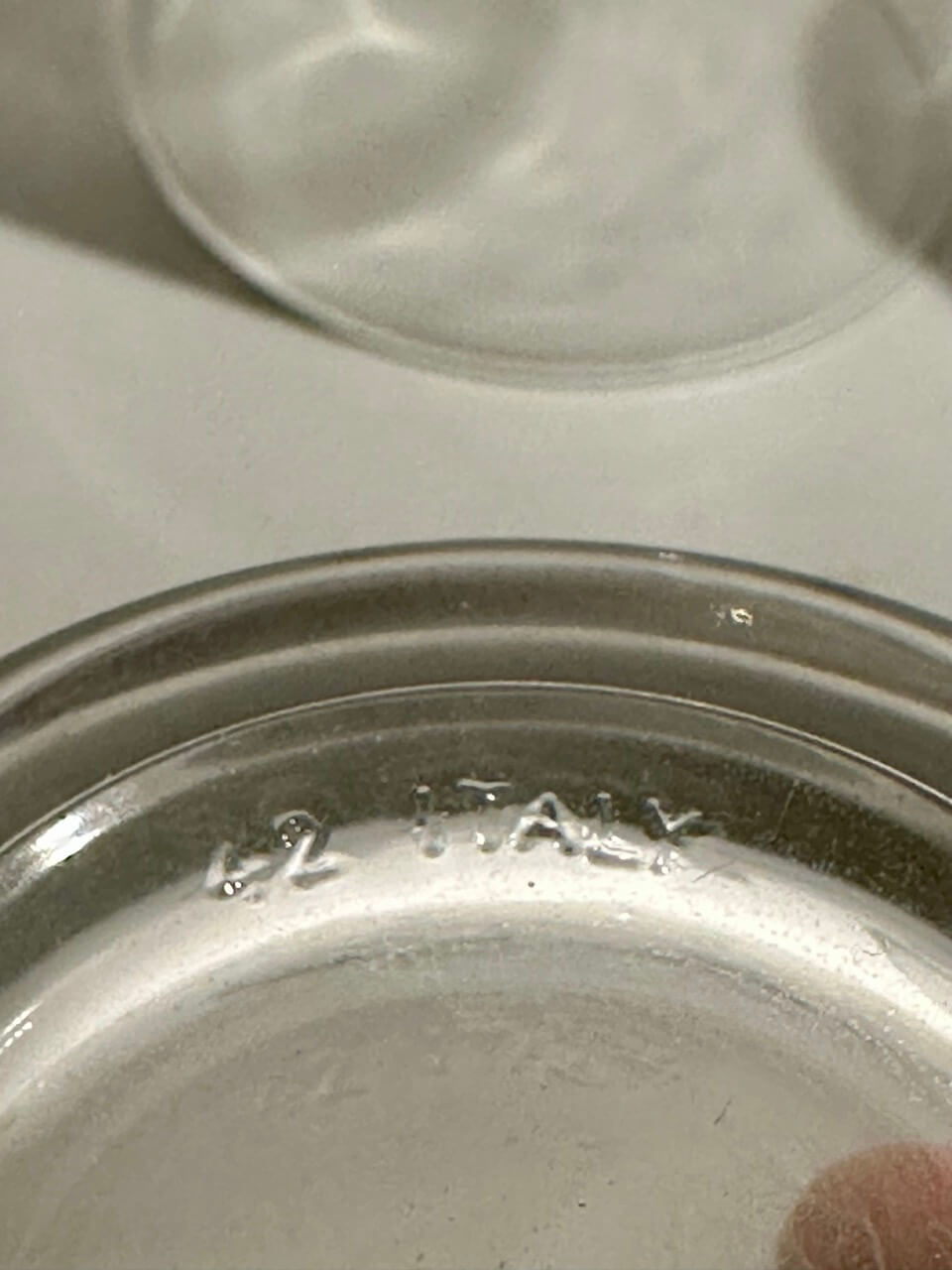Close-up of a glass embossed "42 ITALY"