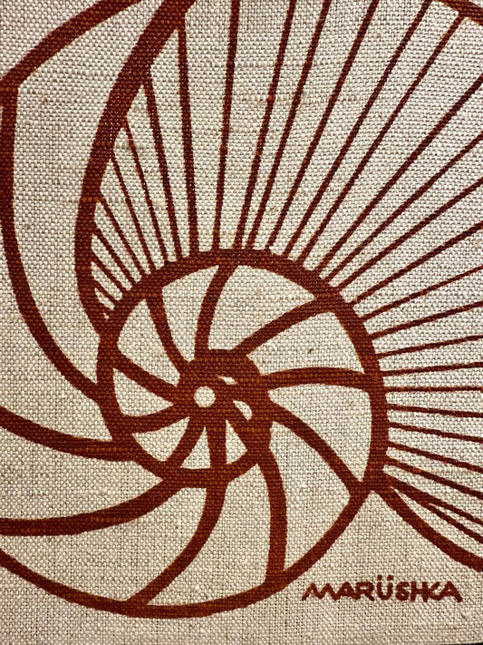 Brown spiral design on beige fabric with 'Marushka' branding.