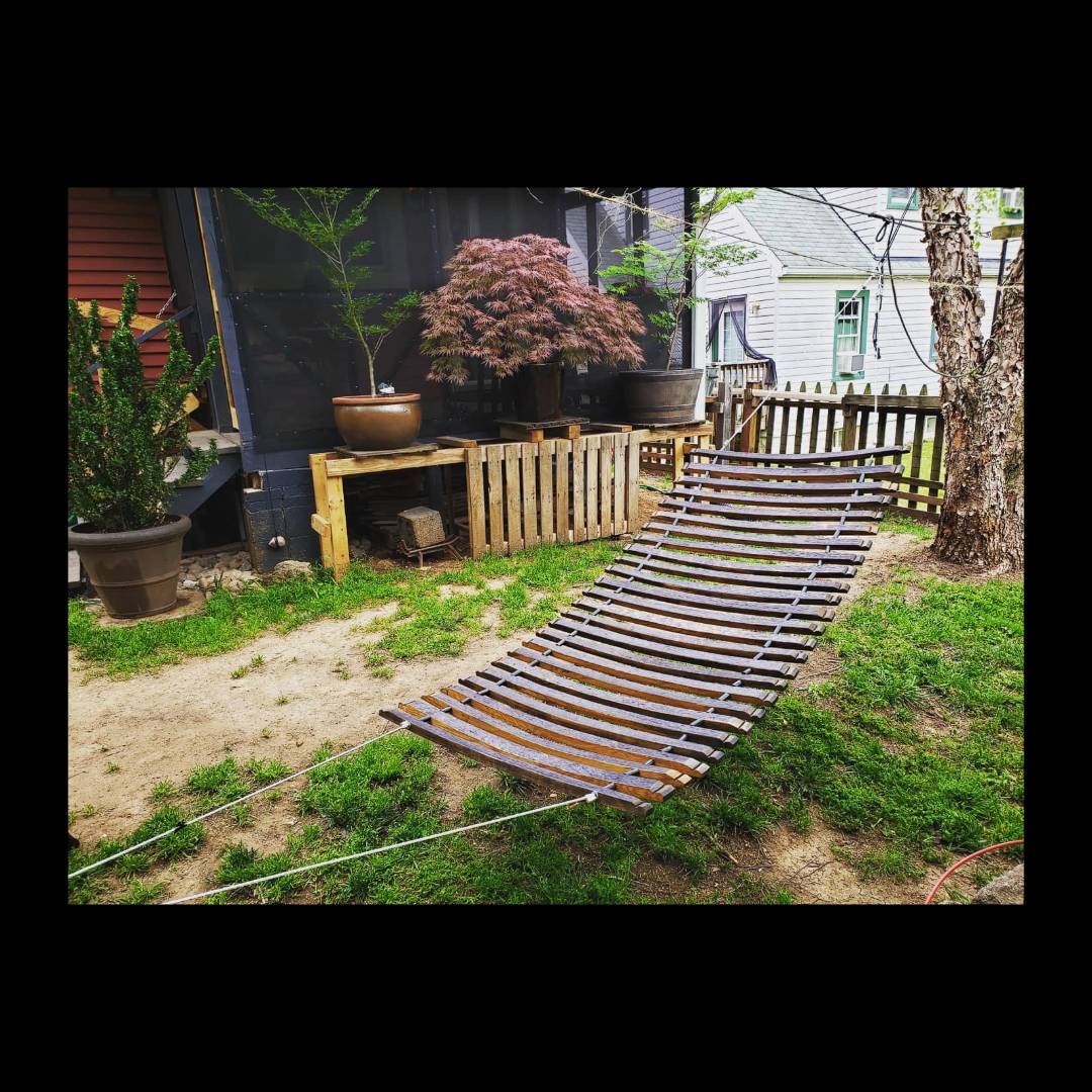 Fox & Thistle Studio hammock made from 26 bourbon barrel staves, connected by steel cable with irrigation hose spacers.
