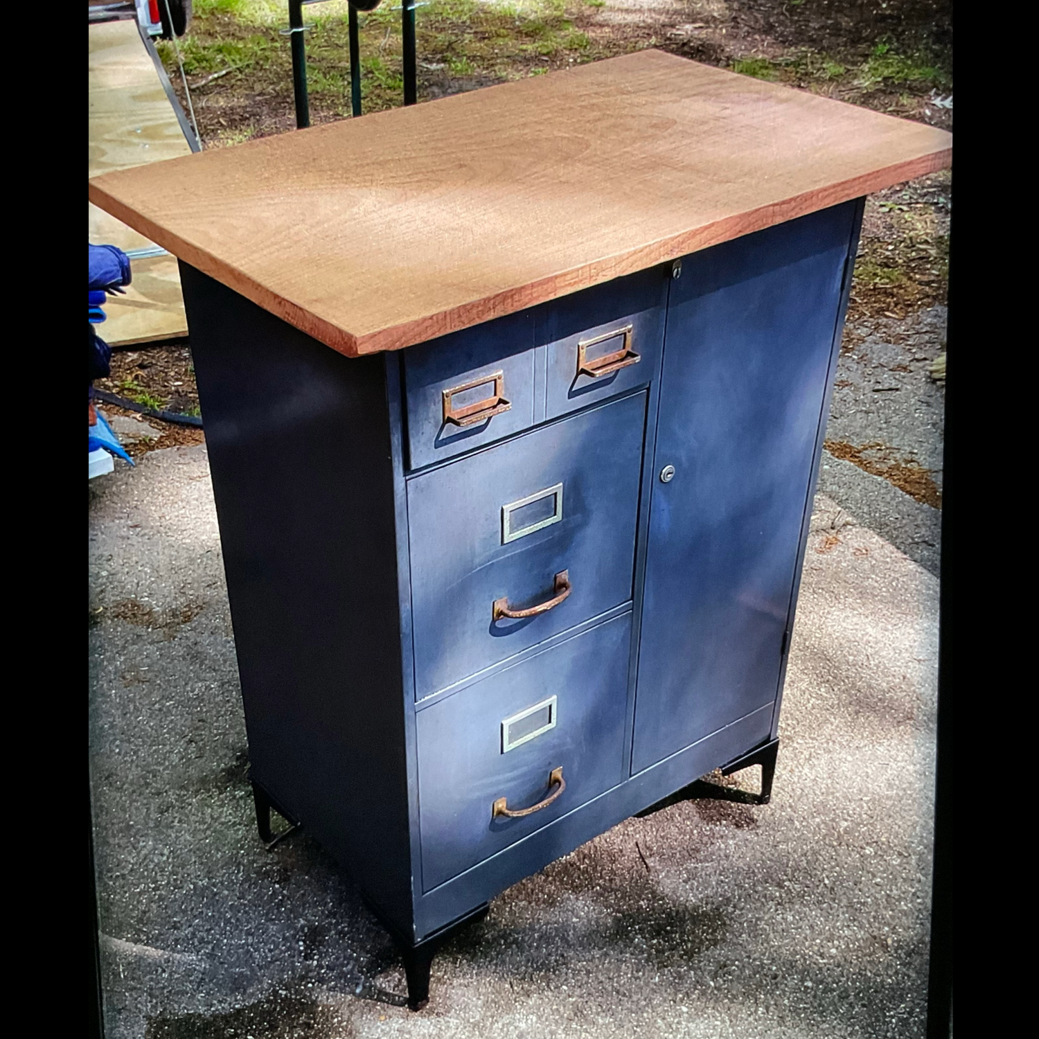 Upcycled file cabinet and locker unit with added metal feet and a polished mahogany wood top.