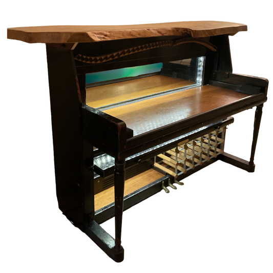 Wooden piano bar with a wine rack underneath on a white background