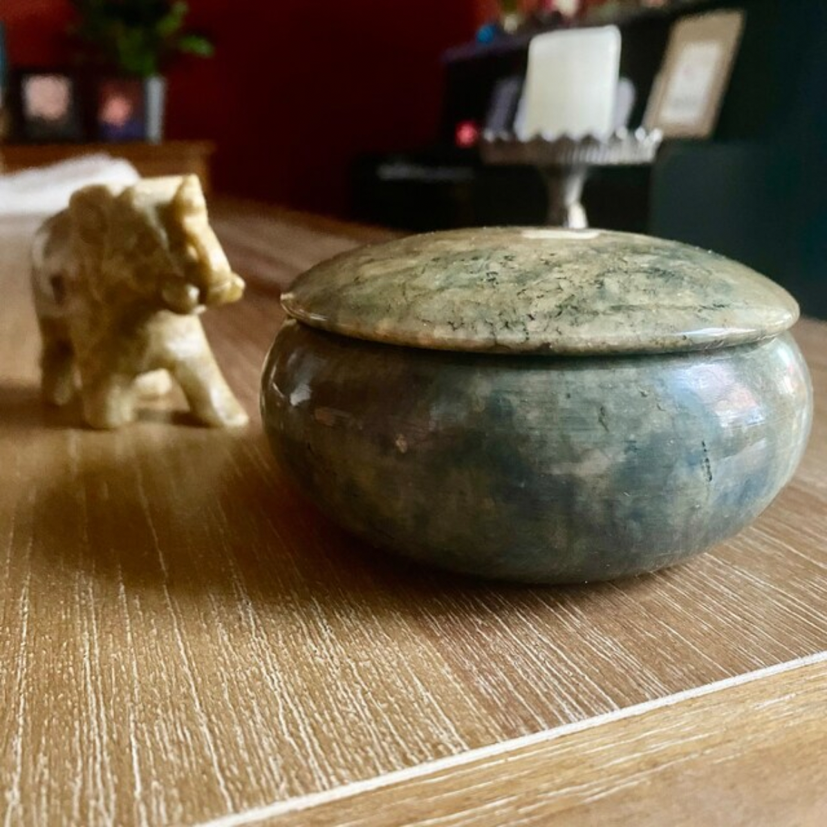 Marble-patterned pot with lid on a wooden surface