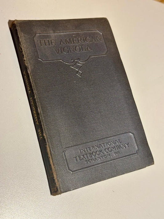 Vintage book with 'The American Vignola' and 'International Textbook Company' embossed on the cover.