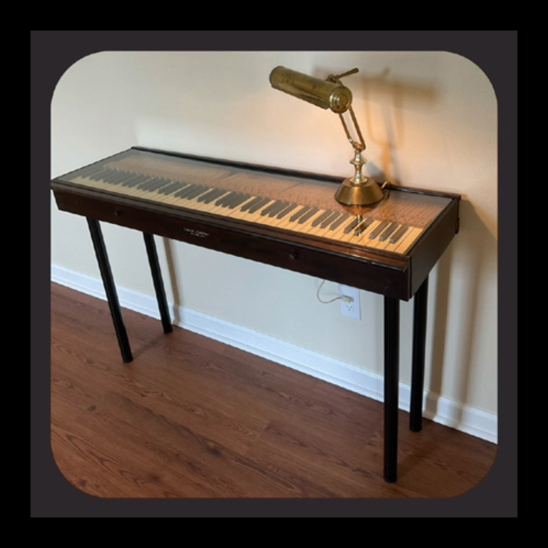 Console table made from an heirloom piano keyboard. The original wood was repurposed to construct the frame, with 1/4" glass across the top and adjustable legs. Featured in Issue 2 of our newsletter, The Liminal.