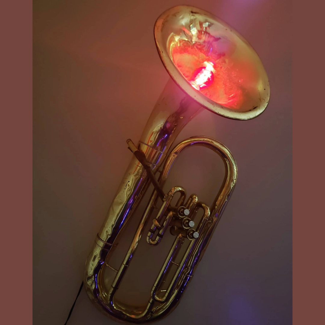 Wall sconce made from a repurposed, weathered euphonium purchased at auction.