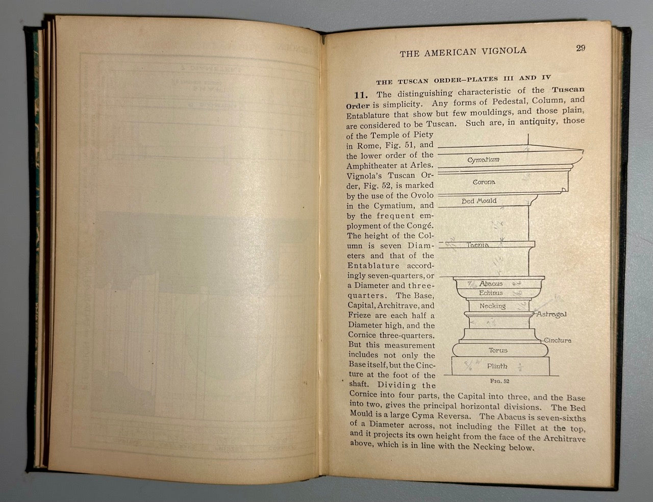 Open book with text and architectural illustrations on a gray background