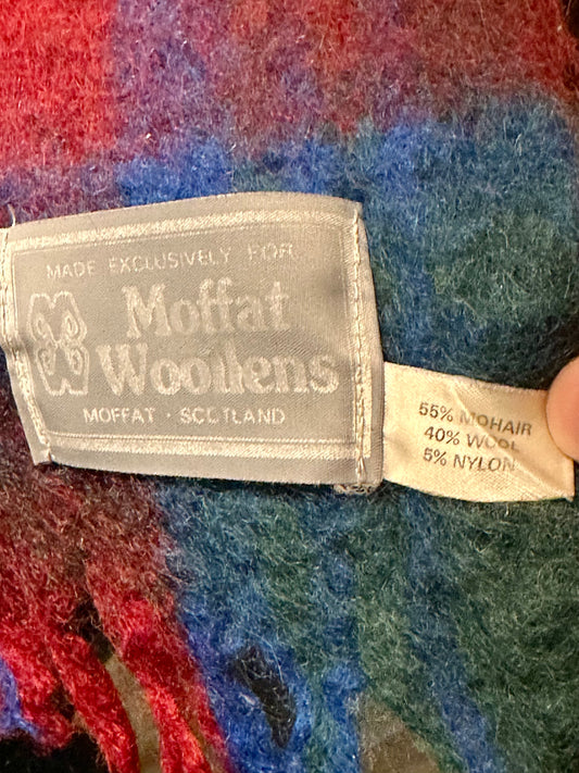 Moffat Woollens label on a multicolored fabric background
