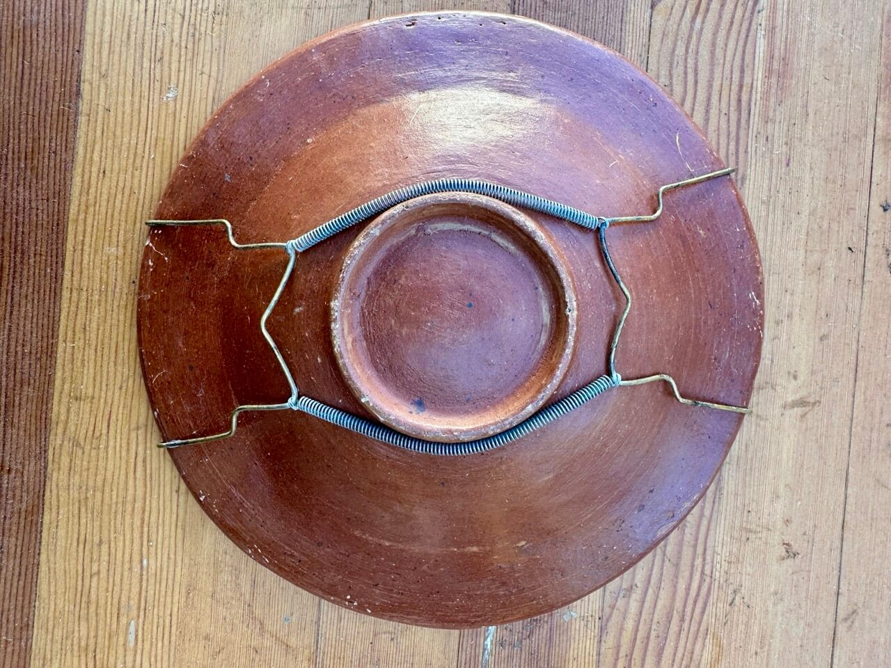 Red ceramic plate on a wooden surface