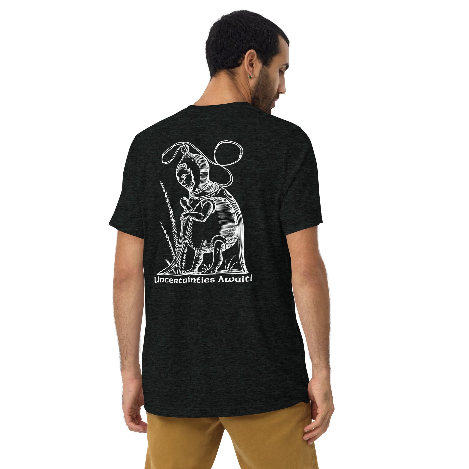 Model seen from behind wearing charcoal black “Uncertainties Await” tee with Pantagruel’s woodcut graphic.